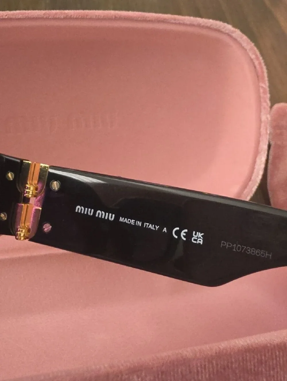Miu Miu Glossy Black Frame Sunglasses with Purple Lenses